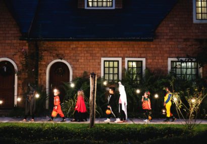 Children going to houses for candy on halloween