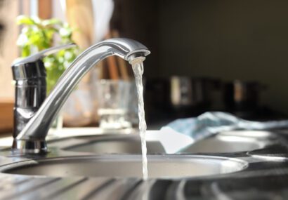 Water running from tap into kitchen sink