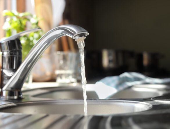 Water running from tap into kitchen sink